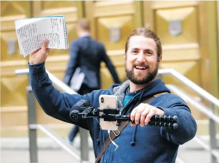  ?? DARREN MAKOWICHUK ?? David Stephan, who was convicted along with his wife in the 2012 death of their 19-month-old son Ezekiel, records a video outside the Calgary Courts Centre on Monday as part of his bid to ensure fairness during the trial of a couple who are charged in a similar case.