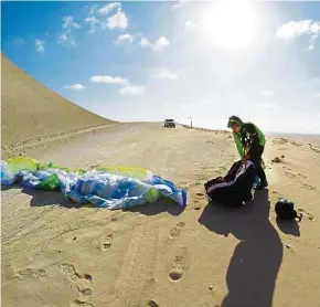  ??  ?? Packing up her glider in Abu Dhabi.