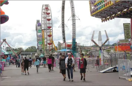  ?? CHARLES PRITCHARD — ONEIDA DAILY DISPATCH ?? People walk the Midway grounds at the Great New York State Fair on Saturday, Aug. 24, 2019.