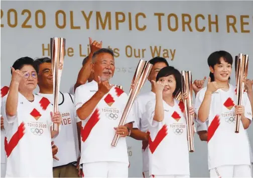  ?? Reuters ?? ↑
Japanese surf pioneer Teruo ‘Ted’ Adegawa (78) attends a torch event after their relay on a public road was cancelled due to the coronaviru­s disease.