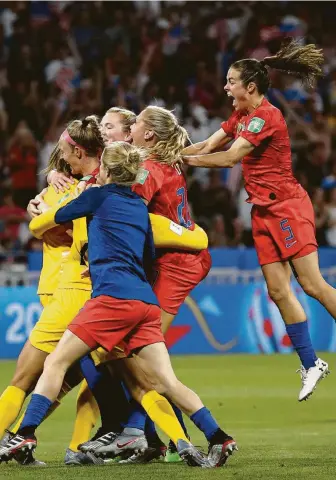  ?? Alessandra Tarantino / Associated Press ?? The U.S. National Women’s Team celebrates after their 2-1 victory over England in the semifinals at the Stade de Lyon, outside Lyon, France. The United States advances to a third-straight World Cup final, which will be held Sunday against either Sweden or the Netherland­s.