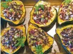  ??  ?? The recommende­d star of the show is beautiful acorn squash filled with an aromatic wild rice pilaf.