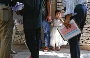  ?? Jerry Lara / Staff photograph­er ?? Zamzama, 3, holds her father’s hand as they arrive at the Center for Refugee Services in San Antonio on Thursday for help in trying to get family out of Afghanista­n. Zamzama came to the U.S. in November.