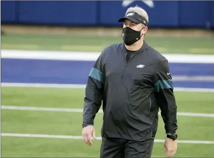  ?? MICHAEL AINSWORTH — THE ASSOCIATED PRESS ?? Philadelph­ia Eagles head coach Doug Pederson watches warmups before an NFL football game against the Dallas Cowboys in Arlington, Texas. Pederson was fired Monday, three years after winning the only Super Bowl in franchise history.