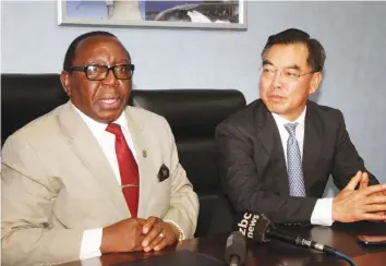  ?? (Picture by Memory Mangombe) ?? Energy and Power Developmen­t Minister Simon Khaya Moyo, flanked by Chinese Ambassador to Zimbabwe Mr Huang Ping, addresses the media in Harare yesterday.