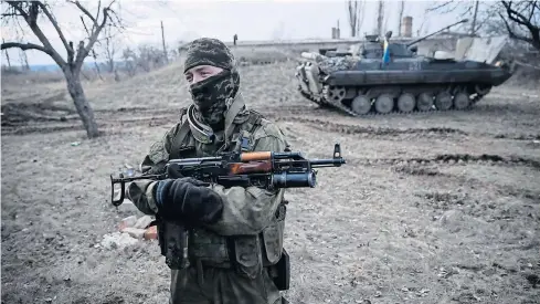  ?? REUTERS ?? A Ukrainian serviceman is pictured at his position near Debaltseve, eastern Ukraine, on Sunday. The leaders of Russia, Ukraine, Germany and France have agreed to meet in Belarus tomorrow to try to broker a peace deal for Ukraine amid escalating...