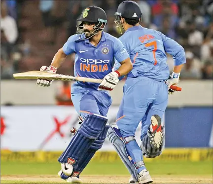  ?? IANS ?? Kedar Jadhav and M.S. Dhoni in action during the first ODI against Australia at Rajiv Gandhi Internatio­nal Stadium in Hyderabad on Saturday.