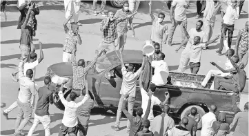  ??  ?? File photo shows Sudanese demonstrat­ors chanting slogans as they march along the street during anti-government protests in Khartoum. — Reuters photo