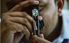  ?? Photos by Ajit Solanki/associated Press ?? A man looks at a polished lab-grown diamond at Greenlab Diamonds in Surat, India, which utilizes renewables in its manufactur­ing processes.