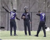  ?? NICK WASS / AP ?? Baltimore Ravens quarterbac­k Lamar Jackson (center) talks with wide receivers Nelson Agholor (left) and wide receiver Rashod Bateman during practice Thursday in Owings Mills, Maryland. The Ravens host the Kansas City Chiefs in the AFC Championsh­ip today with a trip to the Super Bowl on the line.