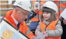  ??  ?? Investment John Swinney MSP with Lucy Smith from the nursery class at Tulloch Primary School in Perth during a visit to a new school site