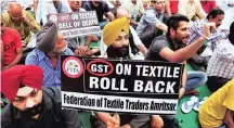 ?? PHOTO: PTI ?? Local traders raise slogans to protest against the GST during a day-long strike in Amritsar on Tuesday