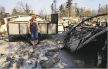  ?? Michael Macor / The Chronicle ?? Kimm Howard stands in front of her destroyed home in the Coffey Park area of Santa Rosa, which lost 2,800 buildings.