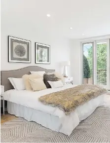  ??  ?? Help fill the space in a large bedroom with a punchy area rug.