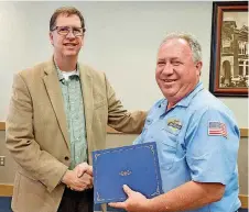  ?? [PHOTO PROVIDED] ?? Cleveland County Commission­er Darry Stacy, left, congratula­tes Roger Harris.