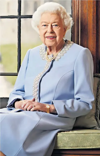  ?? ?? The Queen is captured in a relaxed pose on a window seat at Windsor Castle in a photograph issued last night to mark Britain’s first Platinum Jubilee