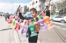  ?? — AFP photo by Mohammed Abed ?? A displaced Palestinia­n child sells handmade Ramadan lanterns in Rafah in the southern Gaza Strip.