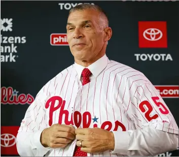  ?? ASSOCIATED PRESS ?? New Phillies new manager Joe Girardi puts on his uniform during a news conference in Philadelph­ia last week.