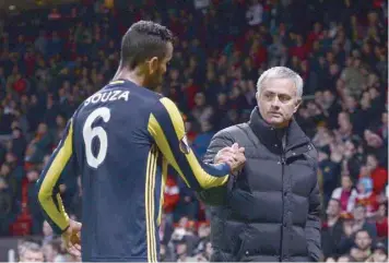  ?? — AFP ?? Manchester United’s manager Jose Mourinho (right) shakes hands with Fenerbahce midfielder Souza (left) at the end of the UEFA Europa League group A match at Old Trafford in Manchester, north west England.