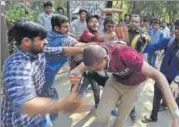  ??  ?? Members of the Akhil Bharatiya Vidyarthi Parishad beat up a Ramjas College student on the college premises.