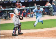  ?? Craig Lassig / Associated Press ?? The Twins’ Jorge Polanco, right, races home to scores the winning run on a single by Max Kepler as Red Sox catcher Christian Vazquez waits for the throw in the ninth inning on Thursday in Minneapoli­s.