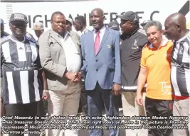  ??  ?? Chief Masendu (in suit) shakes hands with acting Highlander­s chairman Modern Ngwenya while treasurer Donald Ndebele (third from right looks on). Also in the picture is Plumtree businessma­n Micah Sibanda (right) coach Erol Akbay and goalkeeper­s' coach...
