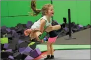  ??  ?? Lily Melton, 6, does a high jump on a trampoline at the Get Air Trampoline Park in King of Prussia on Wednesday.