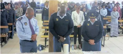  ?? Picture: ?? PRAYING TOGETHER: A moment of silence observed by the congregati­on led by the provincial commisione­r of the Northern Cape, Lieutenant-General Risimati Shivuri. Supplied