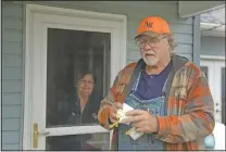  ?? (File photo/AP/Charlie Riedel) ?? Dennis Ruhnke holds two of his remaining N-95 masks April 24 as he stands with his wife, Sharon at their home near Troy, Kan. Dennis, a retired farmer, shipped one of the couple’s five masks left over from his farming days to New York Gov. Andrew Cuomo for use by a doctor or a nurse.