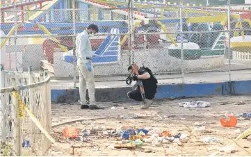  ??  ?? Pakistani security officials collect evidence at the cordoned-off site of the March 27 suicide bombing, in Lahore. — AFP photo