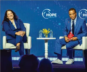  ?? AJC 2023 ?? Operation HOPE founder John Hope Bryant (right), here with SBA’s Isabel Guzman, doesn’t think the ruling will change his group’s work, which includes a partnershi­p with MBDA in the Enterprisi­ng Women of Color program.