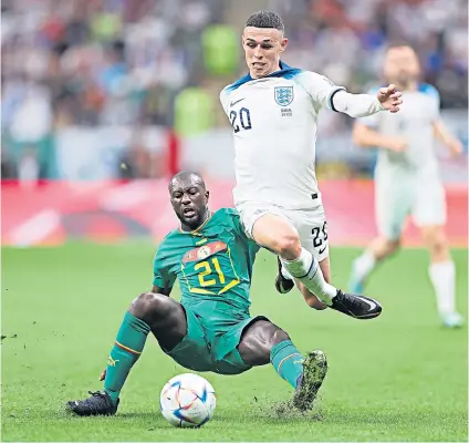  ?? ?? Pulling the strings: Phil Foden hurdles a challenge from Youssouf Sabaly during an enterprisi­ng performanc­e