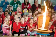  ?? @IMartensHe­rald ?? Mesmerized students look on in awe as the torch is lit during the opening ceremony Monday morning for Winter Olympics Day at Lakeview Elementary School.