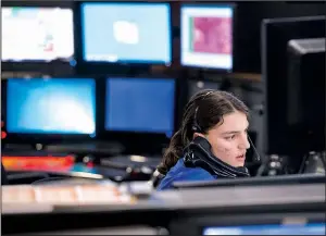  ?? NWA Democrat-Gazette/BEN GOFF ?? Katherine Detter takes a call this month at the 911 center in Rogers. The center, which is in the Rogers Police Department, dispatches calls for Rogers police, fire and medical services.