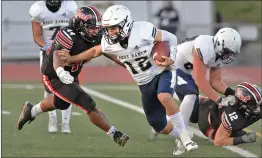  ?? Dan Watson/The Signal ?? (Above) West Ranch quarterbac­k Ryan Staub (12) evades Hart High defender Ryan Rossi (44) at Canyon High School on Thursday. (Left) West Ranch defensive lineman Ryan Lucero (66) sacks Hart High quarterbac­k Tim Larkins (23) in the first quarter of Thursday’s game.