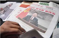  ??  ?? Photo shows a newspaper featuring Xi Jinping at a news stand a day after Xi introduced China’s new Politburo Standing Committee. — AFP photo