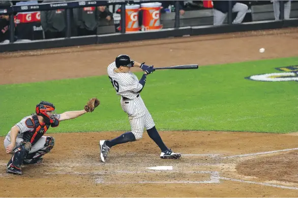  ?? MIKE STOBE/GETTY IMAGES ?? Yankees slugger Aaron Judge connects for a three-run homer in the fourth inning of New York’s 8-1 Game 3 win over the Houston Astros on Monday in New York.