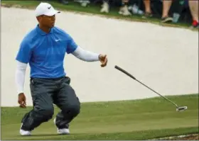  ?? CHARLIE RIEDEL — THE ASSOCIATED PRESS ?? Tiger Woods reacts after missing a birdie putt on the 17th hole during the third round at the Masters golf tournament Saturday in Augusta, Ga.