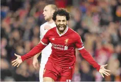  ??  ?? This file photo taken on December 6, 2017 shows Liverpool’s Egyptian midfielder Mohamed Salah celebratin­g scoring their seventh goal during the UEFA Champions League Group E football match between Liverpool and Spartak Moscow at Anfield in Liverpool,...