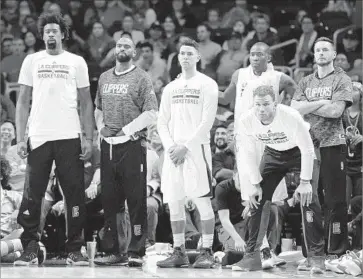  ?? Harry How Getty Images ?? CENTER DeAndre Jordan, left, and forward Blake Griffin, second from right, are among the Clippers who received prominent mention in a survey of league general managers. Jordan ranked No. 1 among centers.