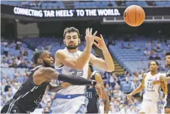  ?? GERRY BROOME ASSOCIATED PRESS ?? North Carolina’s Luke Maye loses the ball while Mount Olive’s Cameron Robinson defends during a Friday exhibition game in Chapel Hill, N.C.