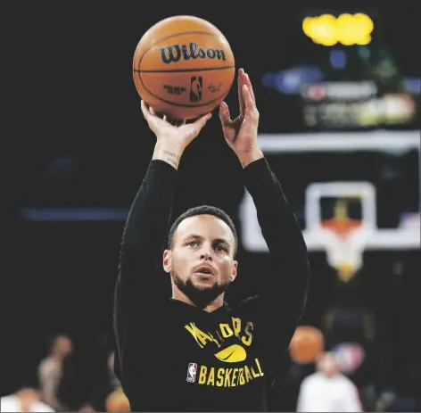  ?? AP PHOTO/RINGO H.W. CHIU ?? Golden State Warriors guard Stephen Curry warms up before a preseason NBA basketball game against the Los Angeles Lakers in Los Angeles, Tuesday.