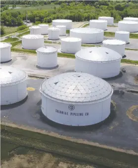  ?? DRONE BASE / REUTERS ?? Holding tanks are seen at Colonial Pipeline's Dorsey Junction Station in Woodbine, Maryland, on Monday. The company was the target of a ransomware attack.