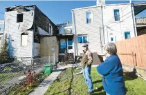  ?? AMY SHORTELL/THE MORNING CALL ?? Donna and Bruce Wetherhold stand at their home Nov. 2 after it suffered damage from a fire in the home next to theirs in Allentown.
