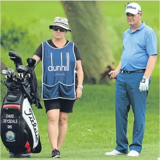  ??  ?? Scot David Drysdale, with wife Victoria on his bag, fired yesterday’s low round.