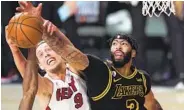  ?? MARK J. TERRILL AP ?? The Lakers’ Anthony Davis got into foul trouble early against Kelly Olynyk and the Heat in Game 3 loss.