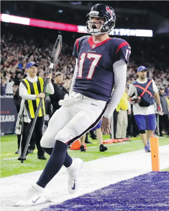  ?? — GETTY IMAGES ?? Texans quarterbac­k Brock Osweiler celebrates after rushing for a touchdown during Houston’s 27-14 AFC wild-card win over the Oakland Raiders Saturday in Houston. Osweiler passed for 168 yards and a touchdown as well.