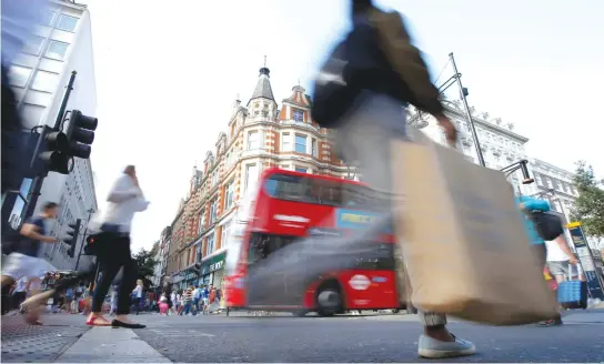  ??  ?? Shoppers cross the road in Oxford Street in London, last August. (Reuters)