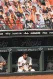  ?? Scott Strazzante / The Chronicle ?? The Giants’ Mauricio Dubón sits below several cardboard cutouts at Oracle Park.