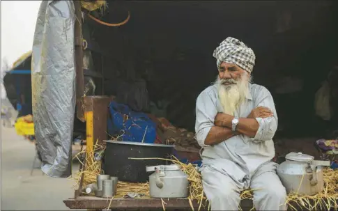  ??  ?? A farmer sits in a tractor trolley during a protest against the newly-passed farm bills at Singhu border near Delhi yesterday.